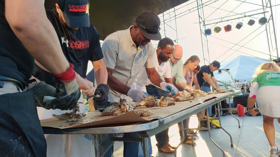 people competing in oyster picking contest at maryland seafood fest