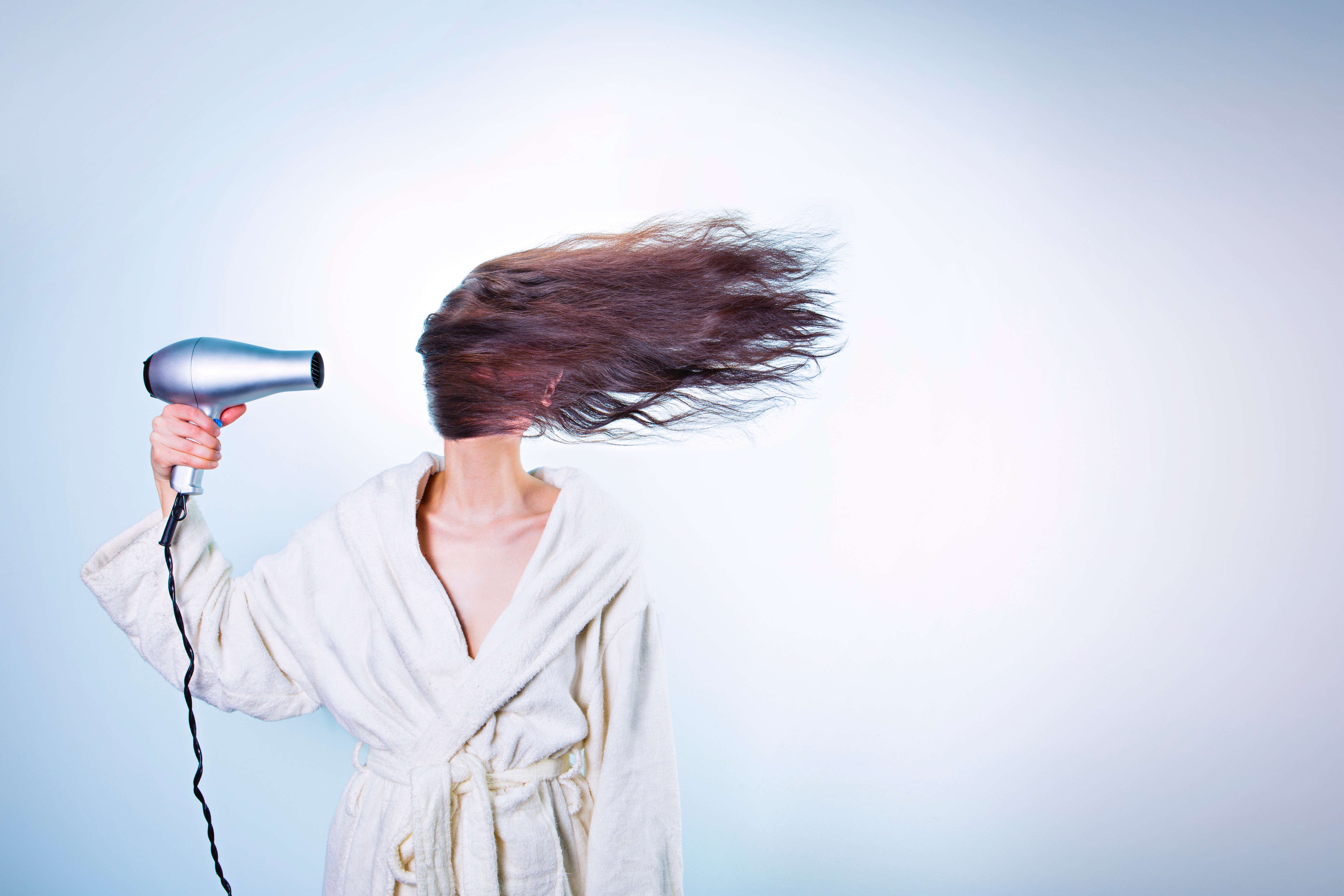 blow drying woman's hair