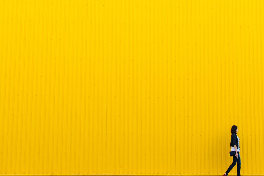 lady walking with yellow background