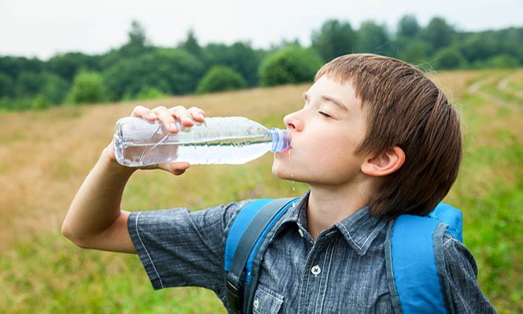 Boy drinking bottled water 