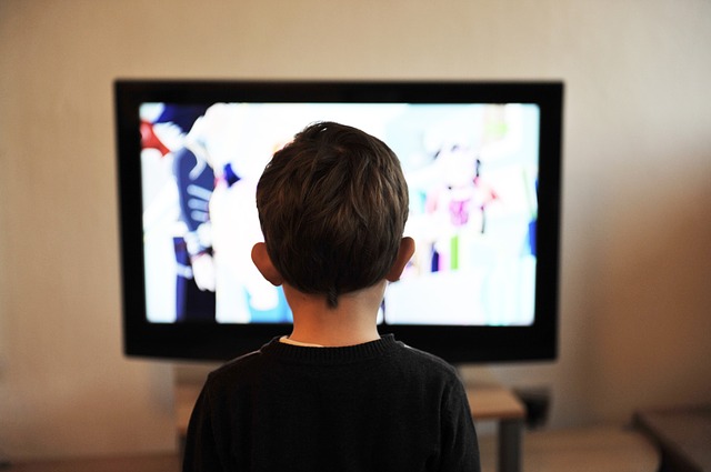 boy in front of tv screen